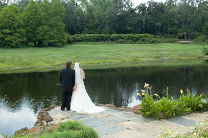 A Bride and Groom holding hands at Bellingrath Gardens.