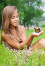 Young lady releasing monarch butterfly.